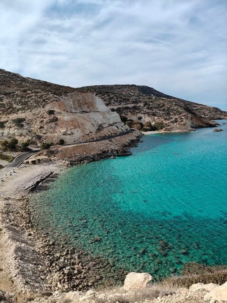 Bay of clear turquoise water fringed by arid hills near Papadiokampos, east Crete