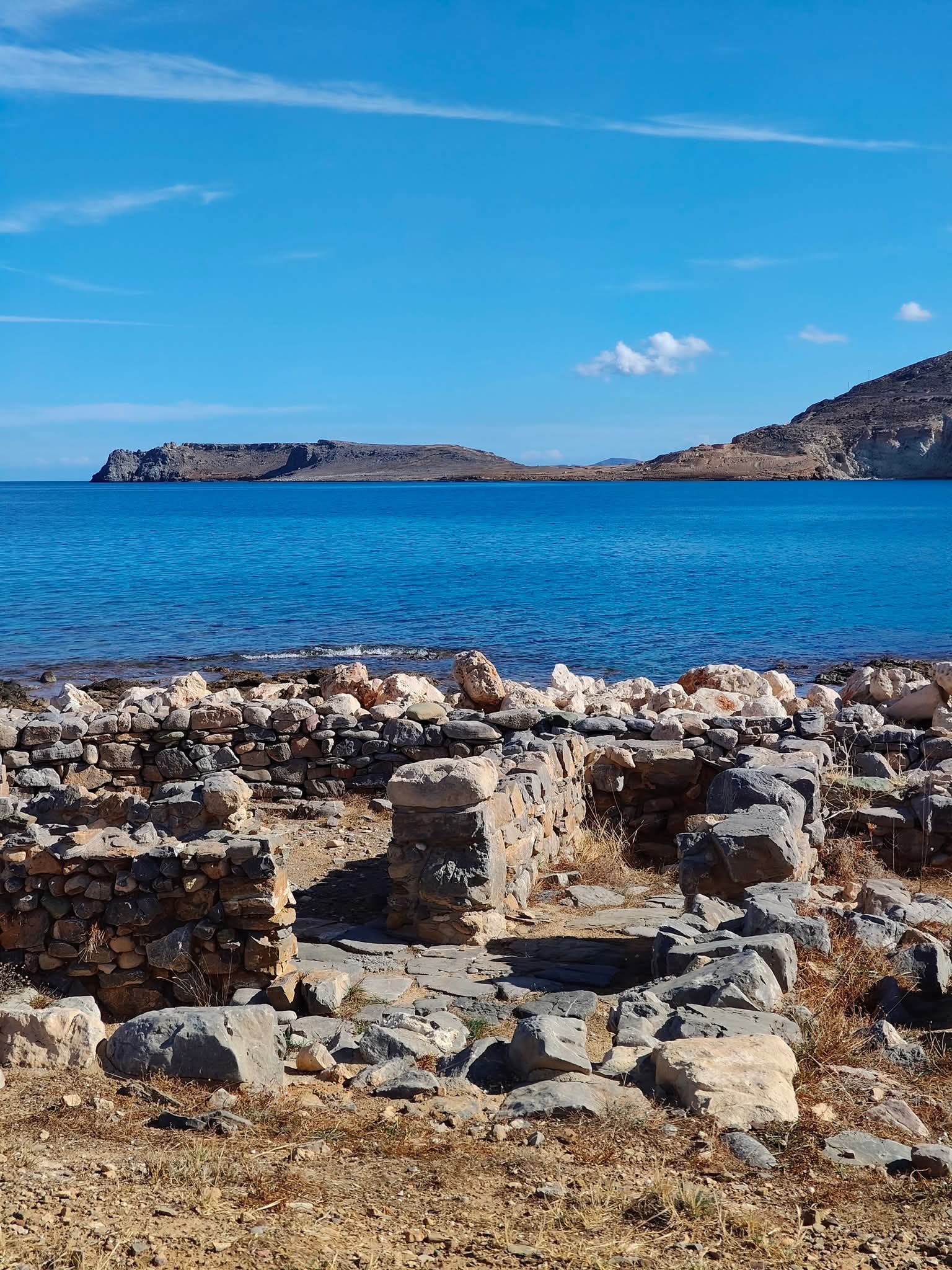 Minoan wall remains by the blue sea at Papadiokampos, near Sitia, Crete
